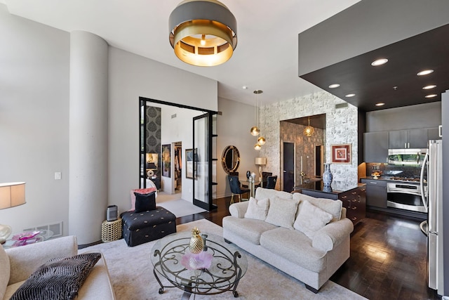 215 10th Ave S Unit 112, Minneapolis, MN 55415 - living room featuring dark wood-style flooring, recessed lighting, and ornate columns