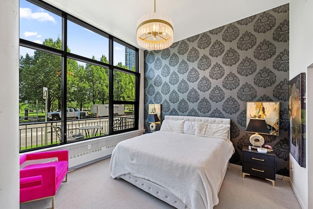 215 10th Ave S Unit 112, Minneapolis, MN 55415 - bedroom featuring wallpapered walls, multiple windows, carpet floors, a baseboard radiator, and a chandelier