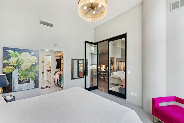 215 10th Ave S Unit 112, Minneapolis, MN 55415 - carpeted bedroom with a closet, a chandelier, and a towering ceiling
