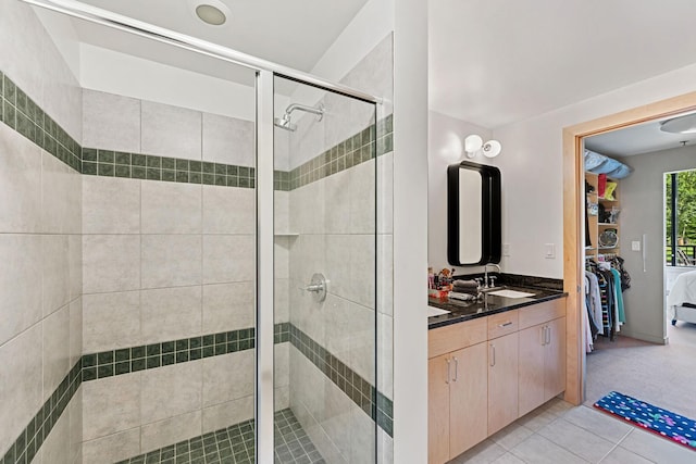 215 10th Ave S Unit 112, Minneapolis, MN 55415 - bathroom featuring a stall shower, vanity, and tile patterned flooring