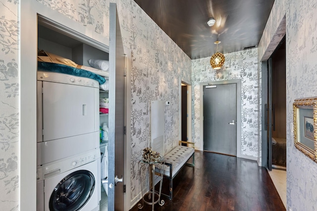 215 10th Ave S Unit 112, Minneapolis, MN 55415 - washroom with stacked washer / drying machine, wallpapered walls, and wood finished floors