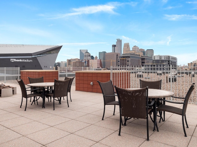 215 10th Ave S Unit 112, Minneapolis, MN 55415 - view of patio with outdoor dining space and a skyline view
