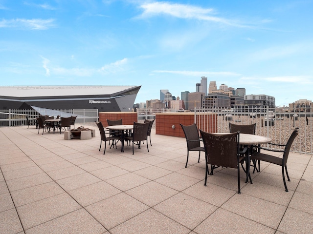 215 10th Ave S Unit 112, Minneapolis, MN 55415 - view of patio featuring outdoor dining area and a skyline view
