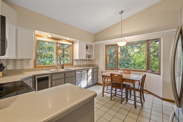 11409 Bren Rd, Minnetonka, MN 55343 - kitchen with stainless steel appliances, beverage cooler, lofted ceiling, decorative backsplash, and white cabinetry