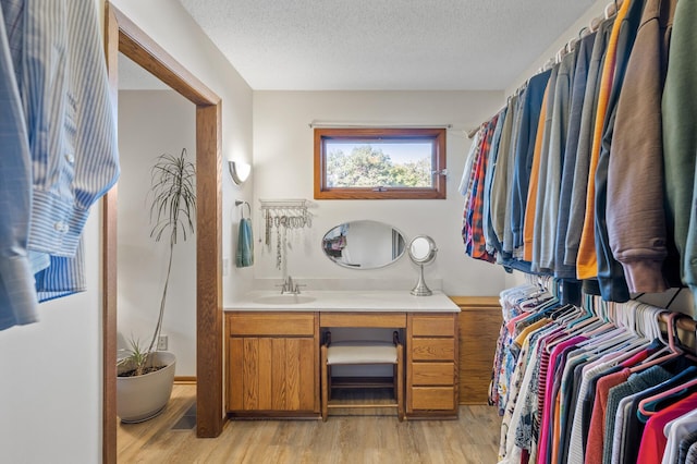 11409 Bren Rd, Minnetonka, MN 55343 - bathroom featuring wood finished floors, vanity, and a textured ceiling
