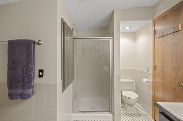 11409 Bren Rd, Minnetonka, MN 55343 - bathroom featuring tile walls, tile patterned flooring, a shower stall, wainscoting, and vanity