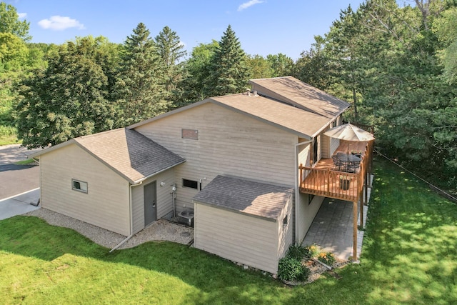 11409 Bren Rd, Minnetonka, MN 55343 - view of home's exterior with a wooden deck, a yard, and roof with shingles