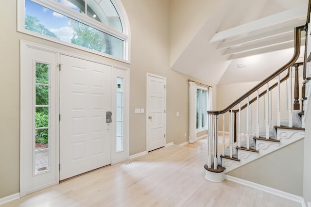 7005 Valley View Rd, Edina, MN 55439 - entrance foyer with wood finished floors, high vaulted ceiling, and stairs