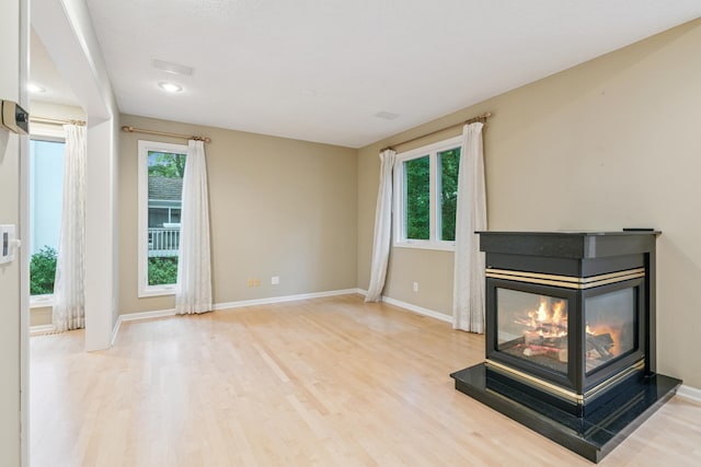 7005 Valley View Rd, Edina, MN 55439 - unfurnished living room featuring wood finished floors, healthy amount of natural light, a multi sided fireplace, and recessed lighting