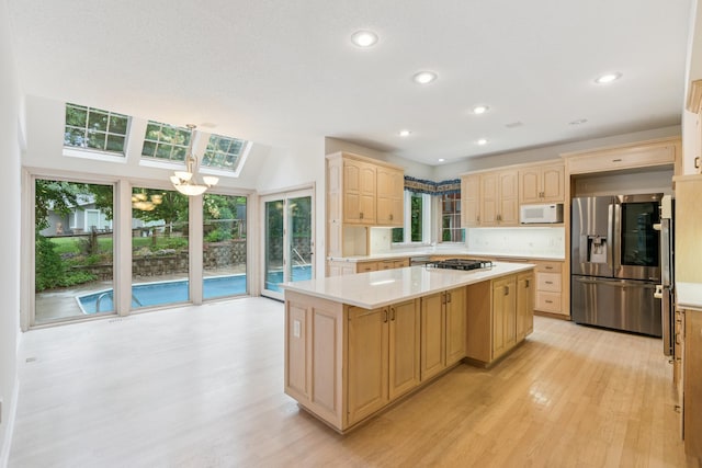 7005 Valley View Rd, Edina, MN 55439 - kitchen with stainless steel appliances, light wood-style floors, light brown cabinets, light countertops, and recessed lighting