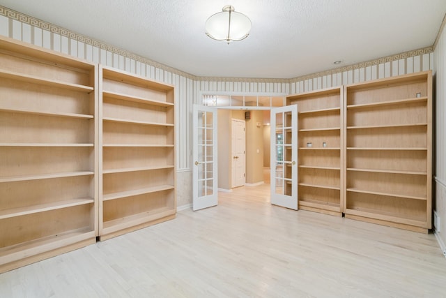 7005 Valley View Rd, Edina, MN 55439 - spare room featuring french doors, wood finished floors, wallpapered walls, and a textured ceiling