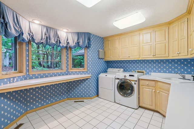 7005 Valley View Rd, Edina, MN 55439 - laundry area featuring wallpapered walls, washing machine and clothes dryer, cabinet space, and a textured ceiling