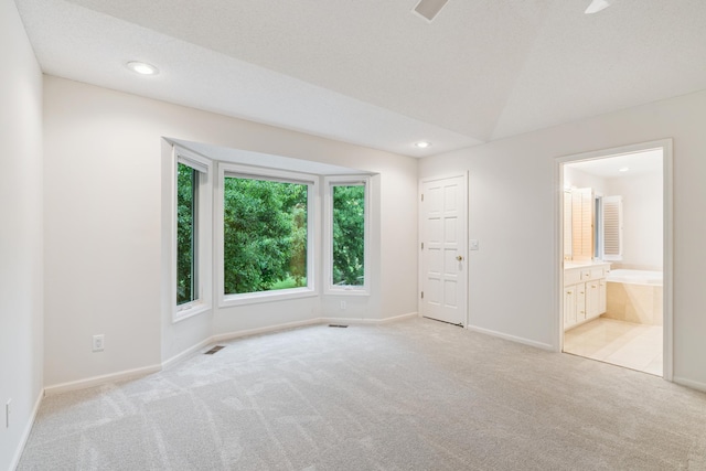 7005 Valley View Rd, Edina, MN 55439 - unfurnished bedroom featuring light carpet, recessed lighting, and ensuite bath
