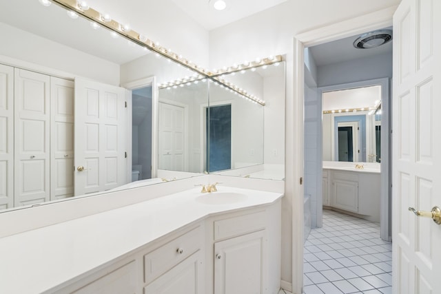 7005 Valley View Rd, Edina, MN 55439 - bathroom with vanity, tile patterned flooring, and a tub