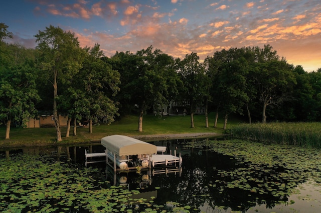 27858 Nathan Ln, Chisago Lake Twp, MN 55045 - dock area featuring a water view, boat lift, a lawn, and view of wooded area