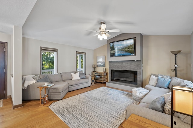27858 Nathan Ln, Chisago Lake Twp, MN 55045 - living area with lofted ceiling, ceiling fan, light wood-type flooring, and a glass covered fireplace