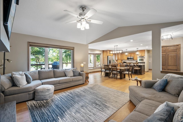 27858 Nathan Ln, Chisago Lake Twp, MN 55045 - living area with a ceiling fan, lofted ceiling, light wood-style flooring, and recessed lighting