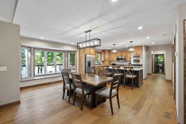 27858 Nathan Ln, Chisago Lake Twp, MN 55045 - dining space featuring recessed lighting, light wood finished floors, washer / clothes dryer, and a textured ceiling