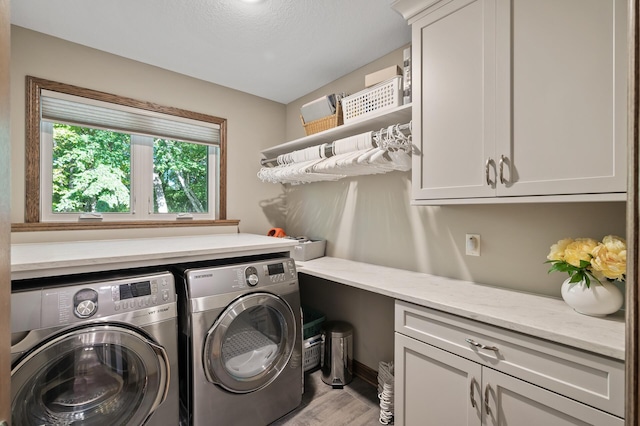 27858 Nathan Ln, Chisago Lake Twp, MN 55045 - washroom featuring cabinet space, washer and clothes dryer, and wood finished floors