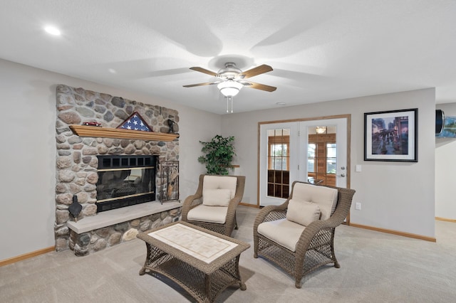 27858 Nathan Ln, Chisago Lake Twp, MN 55045 - living room with a ceiling fan, light carpet, a stone fireplace, and french doors