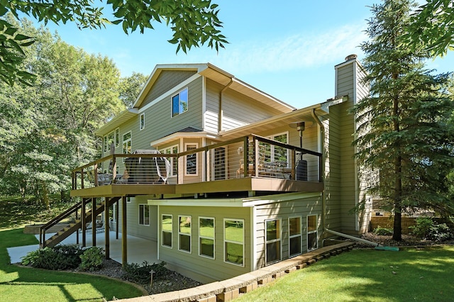 27858 Nathan Ln, Chisago Lake Twp, MN 55045 - rear view of property with a yard, a chimney, a patio area, and stairway