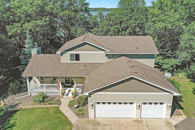 27858 Nathan Ln, Chisago Lake Twp, MN 55045 - view of front facade featuring covered porch, a garage, concrete driveway, a chimney, and stone siding