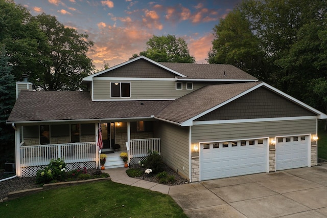 27858 Nathan Ln, Chisago Lake Twp, MN 55045 - view of front of house featuring a garage, a porch, concrete driveway, a shingled roof, and stone siding