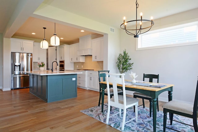 5120 Coronado Dr, Woodbury, MN 55129 - dining area with a chandelier, light wood-style flooring, and recessed lighting