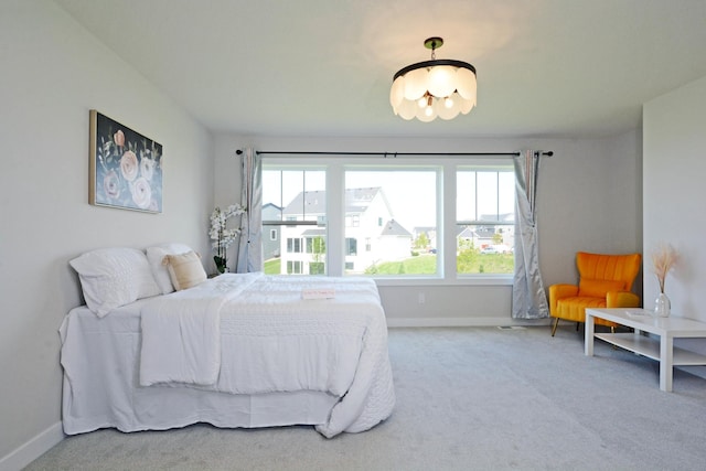 5120 Coronado Dr, Woodbury, MN 55129 - carpeted bedroom with baseboards and a chandelier
