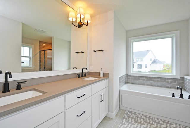 5120 Coronado Dr, Woodbury, MN 55129 - full bath with a bath, double vanity, tile patterned flooring, a chandelier, and a stall shower