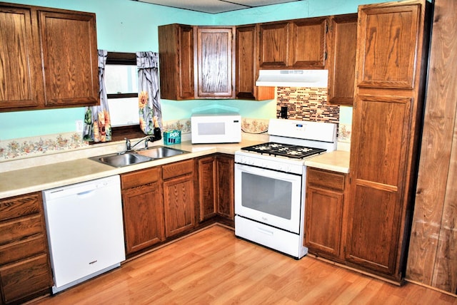 1015 Grove St, Brainerd, MN 56401 - kitchen with white appliances, under cabinet range hood, light wood-style flooring, and light countertops