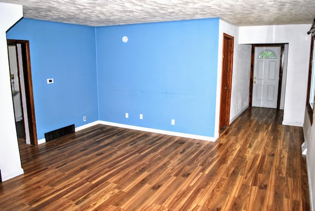 1015 Grove St, Brainerd, MN 56401 - unfurnished room featuring a textured ceiling and dark wood-style floors