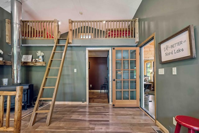 38985 337th Ln, Aitkin, MN 56431 - bedroom featuring french doors, wood finished floors, and high vaulted ceiling
