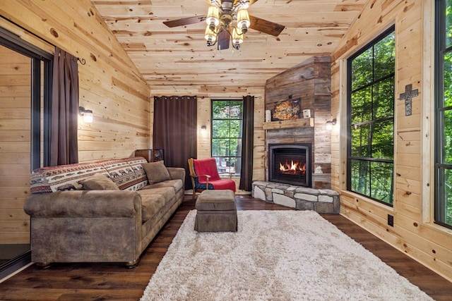 38985 337th Ln, Aitkin, MN 56431 - living room with vaulted ceiling, wood ceiling, a ceiling fan, wooden walls, and a fireplace