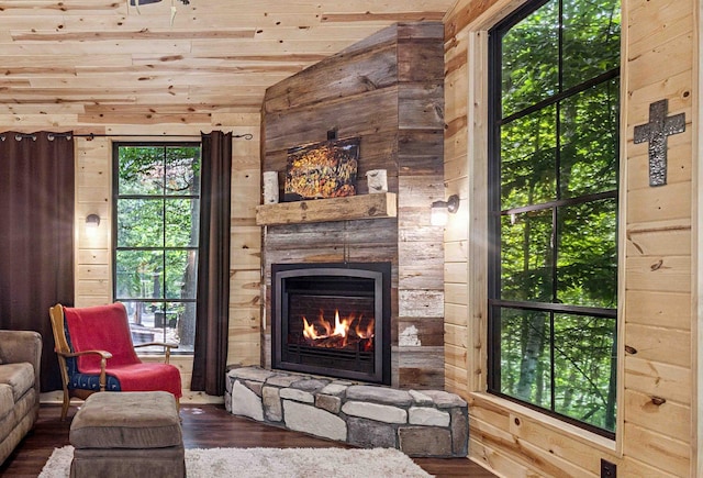 38985 337th Ln, Aitkin, MN 56431 - living room featuring wood walls, wood finished floors, a stone fireplace, lofted ceiling, and wooden ceiling