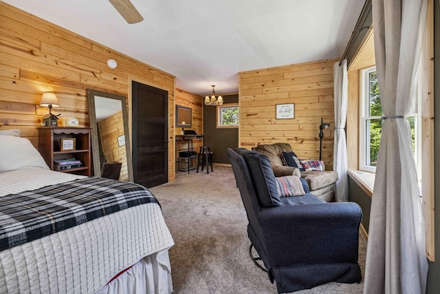 38985 337th Ln, Aitkin, MN 56431 - carpeted bedroom with wooden walls, a chandelier, and a ceiling fan