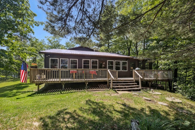 38985 337th Ln, Aitkin, MN 56431 - rear view of house featuring a wooden deck, a yard, and a metal roof