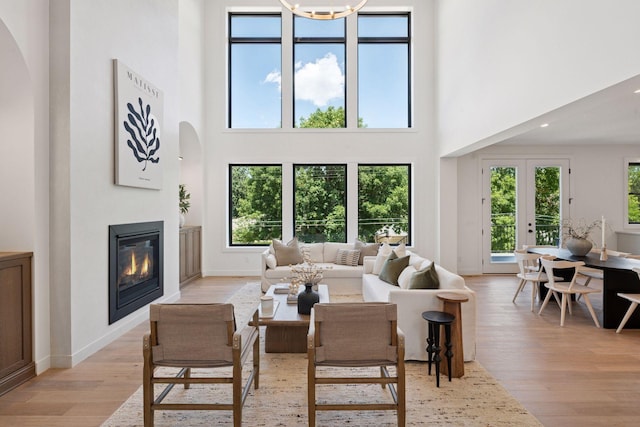 4404 58th St, Edina, MN 55424 - living room featuring a high ceiling, light wood-style floors, arched walkways, healthy amount of natural light, and recessed lighting