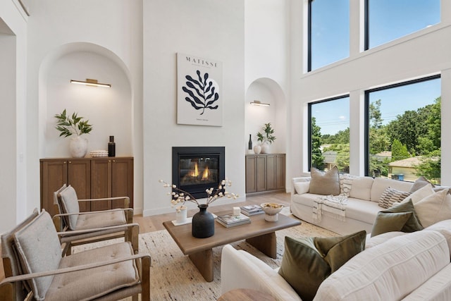 4404 58th St, Edina, MN 55424 - living area featuring a towering ceiling, light wood-style floors, and a glass covered fireplace