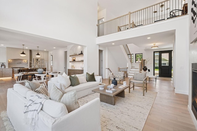 4404 58th St, Edina, MN 55424 - living area with light wood-style flooring, stairway, a towering ceiling, and recessed lighting
