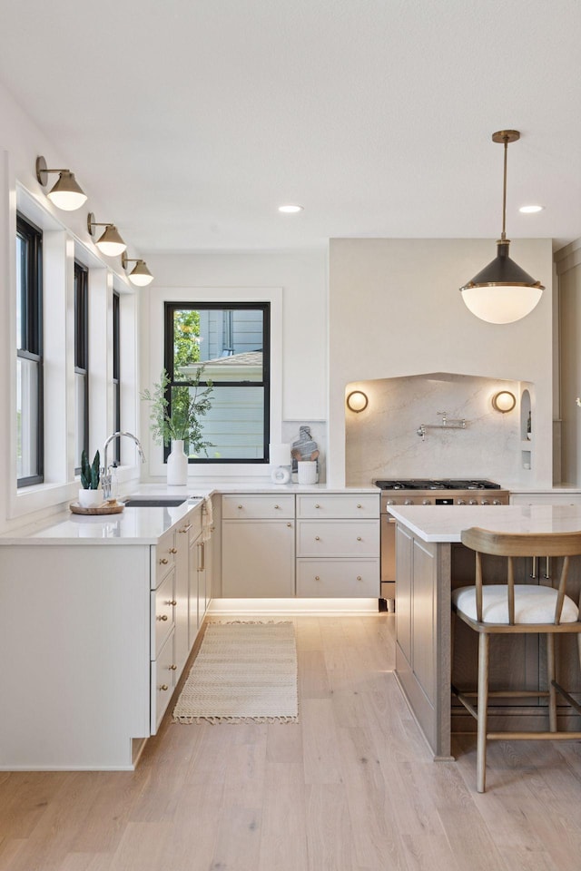 4404 58th St, Edina, MN 55424 - kitchen featuring light countertops, light wood-style flooring, white cabinetry, hanging light fixtures, and recessed lighting