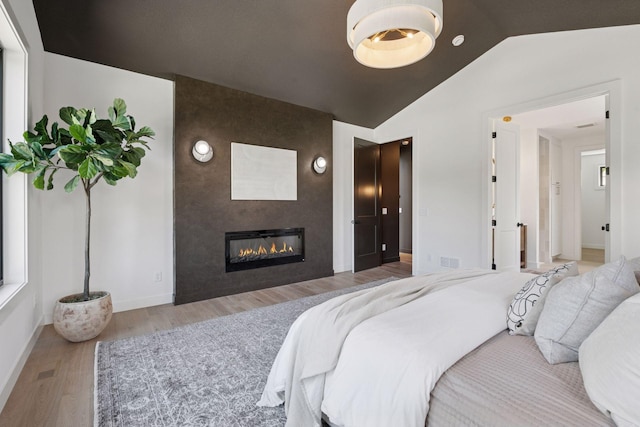 4404 58th St, Edina, MN 55424 - bedroom featuring wood finished floors, a fireplace, and lofted ceiling