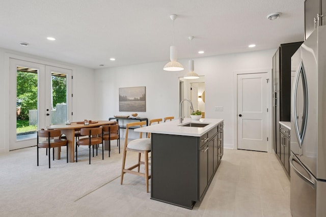 4404 58th St, Edina, MN 55424 - kitchen with freestanding refrigerator, an island with sink, light countertops, recessed lighting, and pendant lighting