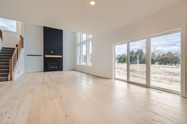 917 174th Ave NE, Ham Lake, MN 55304 - unfurnished living room featuring stairway, light wood finished floors, a large fireplace, and recessed lighting