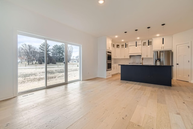 917 174th Ave NE, Ham Lake, MN 55304 - kitchen with appliances with stainless steel finishes, decorative backsplash, white cabinets, recessed lighting, and light wood-style flooring
