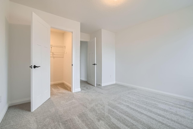 917 174th Ave NE, Ham Lake, MN 55304 - unfurnished bedroom featuring carpet, a walk in closet, and a closet
