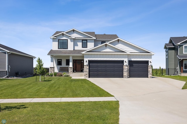 8871 Cottonwood Blvd, Horace, ND 58047 - craftsman house with board and batten siding, concrete driveway, an attached garage, and stone siding
