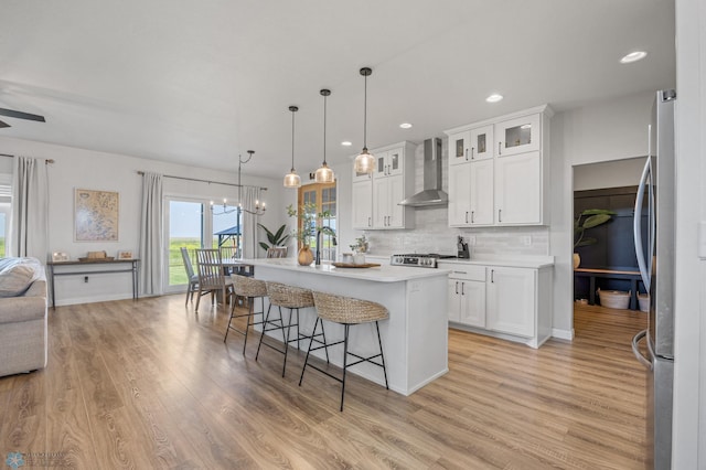8871 Cottonwood Blvd, Horace, ND 58047 - kitchen with wall chimney range hood, freestanding refrigerator, open floor plan, a kitchen breakfast bar, and tasteful backsplash