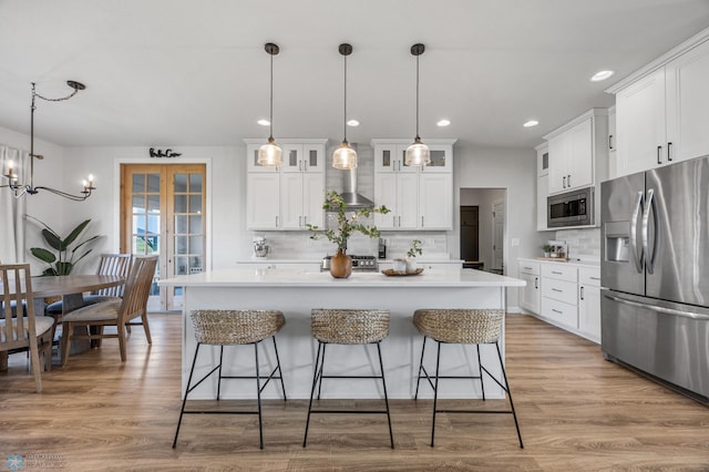 8871 Cottonwood Blvd, Horace, ND 58047 - kitchen featuring appliances with stainless steel finishes, backsplash, a kitchen breakfast bar, and recessed lighting