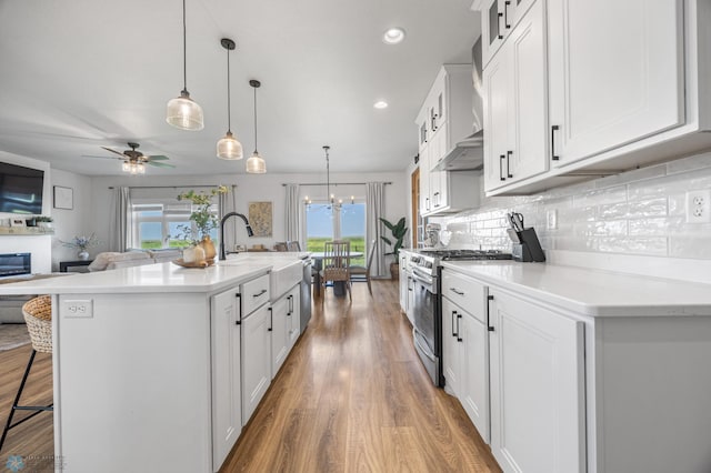 8871 Cottonwood Blvd, Horace, ND 58047 - kitchen featuring stainless steel appliances, open floor plan, a kitchen breakfast bar, wood finished floors, and white cabinetry